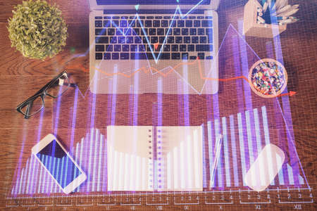 Stock market graph and top view computer on the table background. Multi exposure. Concept of...