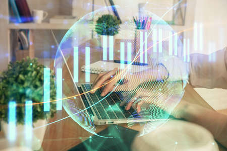 Double exposure of woman hands typing on computer and forex chart hologram drawing. Stock market...