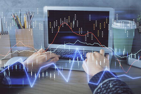 Double exposure of woman hands typing on computer and forex chart hologram drawing. Stock market...