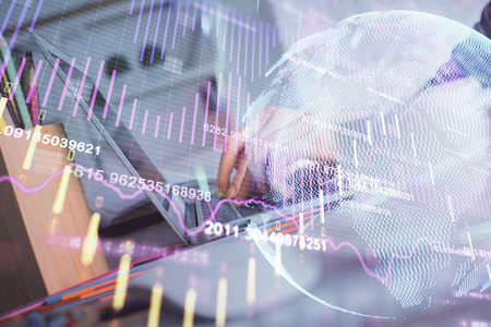 Double exposure of woman hands typing on computer and forex chart hologram drawing. Stock market...