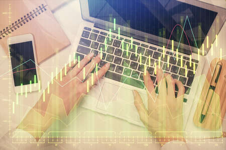 Double exposure of woman hands working on computer and forex graph hologram drawing. Top View....