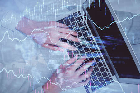 Double exposure of woman hands working on computer and forex chart hologram drawing. Top View....