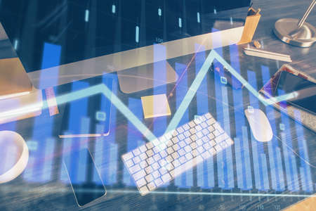 Multi exposure of chart and financial info and work space with computer background. Concept of...