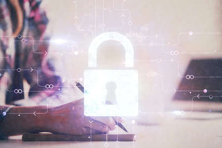 Double exposure of hands making notes with lock icons. Concept security and protection of data