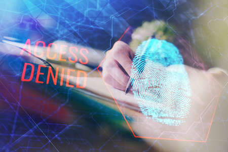 Blue fingerprint hologram over hands taking notes background. Concept of security. Double exposureの写真素材