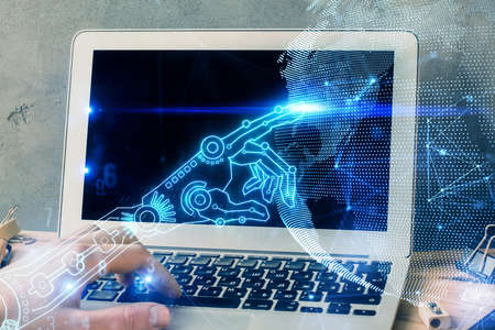 Technology theme hologram with man working on computer on background. High tech concept. Multi...