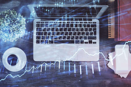 Stock market chart and top view computer on the table background. Double exposure. Concept of...