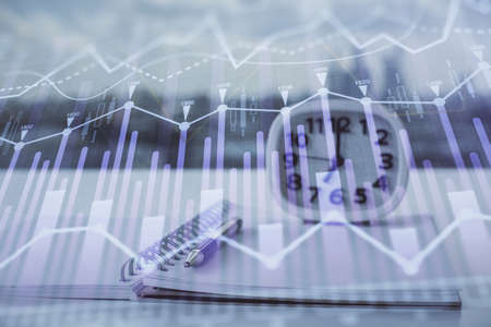 Multi exposure of financial graph drawings and desk with open notebook background. Concept of forex