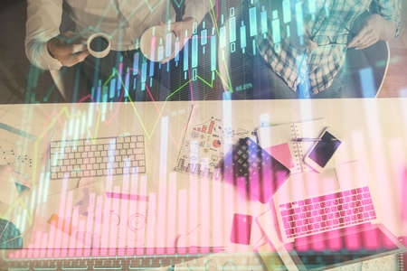 Double exposure of man and woman working together and financial chart hologram drawing. market...