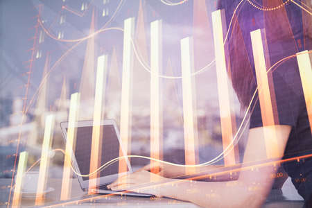 Double exposure of businesswoman hands typing on computer and forex chart hologram drawing....