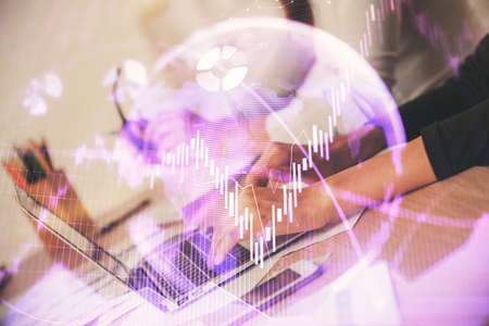 Multi exposure of woman hands typing on computer and financial chart hologram drawing. Stock market...