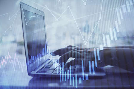 Double exposure of woman hands typing on computer and forex chart hologram drawing. Stock market...