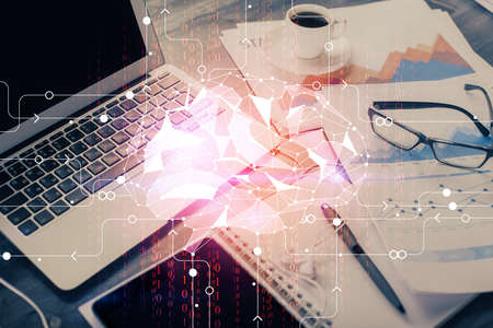 Double exposure of desktop with computer and brain drawing hologram. Artificial intelligence...