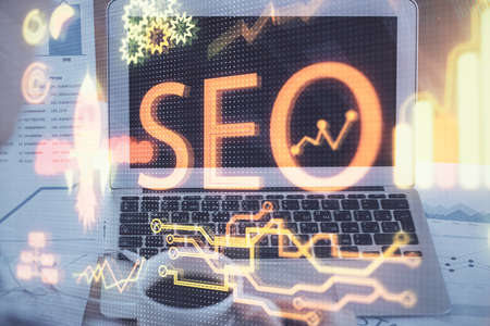 Multi exposure of table with computer and seo drawing hologram. Search optimization concept.の写真素材