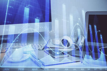 Stock market graph and table with computer background. Multi exposure. Concept of financial...