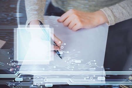 Double exposure of writing hand on background with data technology hologram. Big data concept.