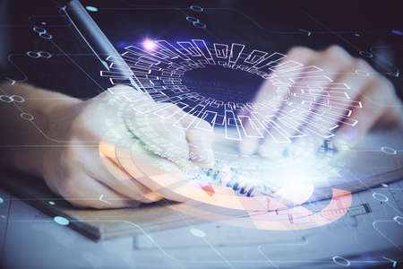 Double exposure of writing hands on background with data solution hologram on front. Technology...