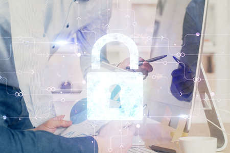 Multi exposure of lock icon with man working on computer on background. Concept of network...