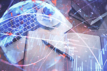 Stock market graph and top view computer on the table background. Multi exposure. Concept of...