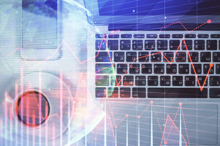 Stock market chart and top view computer on the table background. Multi exposure. Concept of...