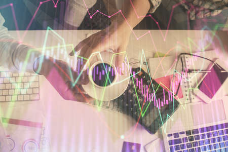 Double exposure of man and woman working together and financial chart hologram drawing. market...