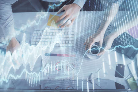 Double exposure of man and woman working together and financial chart hologram drawing. market...