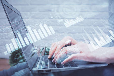 Multi exposure of woman hands typing on computer and forex chart hologram drawing. Stock market...
