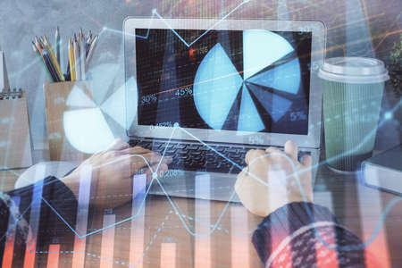 Double exposure of woman hands typing on computer and forex chart hologram drawing. Stock market...