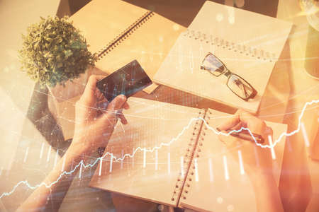 Multi exposure of woman on-line shopping holding a credit card and financial graph drawing. Stock...