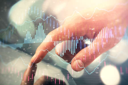 Multi exposure of mans hands holding and using a phone and financial chart drawing. Market analysis...