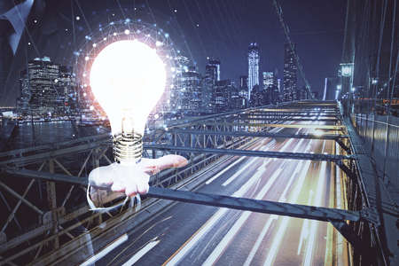 Multi exposure of bulb hologram drawing and cityscape background. Concept of idea.の写真素材