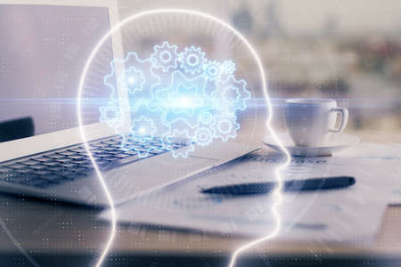 Double exposure of desktop with computer and brain drawing hologram. Artificial intelligence...