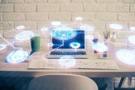 Computer on desktop with social network hologram. Multi exposure. Concept of international people connections.の写真素材