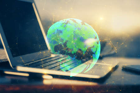 Computer on desktop with social network hologram. Multi exposure. Concept of international people connections.の写真素材
