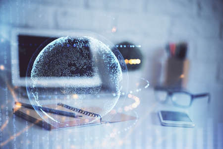 Double exposure of desktop with computer and world map hologram. International data network concept.の写真素材