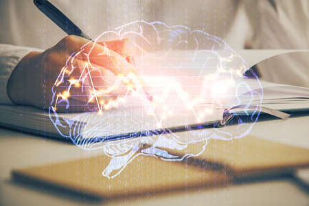 Double exposure of womans writing hand on background with brain hologram. Concept of brainstorming.の写真素材