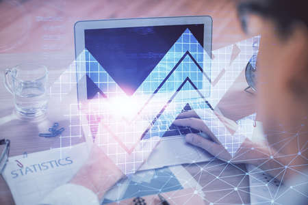 Growing arrows with businessman working on computer on background. Success concept. Double exposure.
