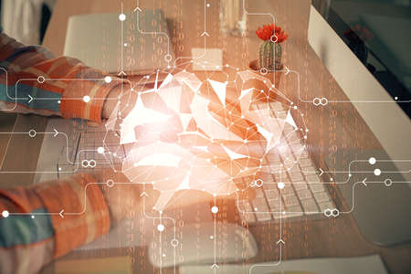 Man typing on keyboard background with brain hologram. Concept of big Data. Double exposure.の写真素材