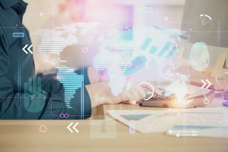 Double exposure of world map hologram with man working on computer on background. Concept of...