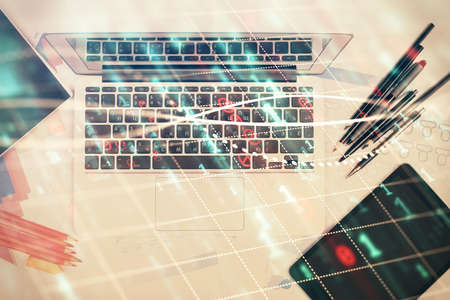 Multi exposure of forex chart drawing over table background with computer. Concept of financial research and analysis. Top view.の写真素材