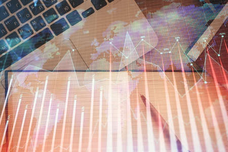 Stock market chart and top view computer on the table background. Double exposure. Concept of financial analysis.の写真素材