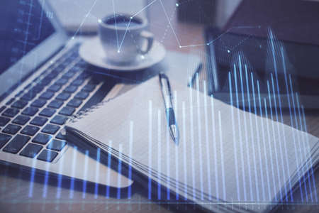 Double exposure of forex chart drawing and desktop with coffee and items on table background. Concept of financial market tradingの写真素材