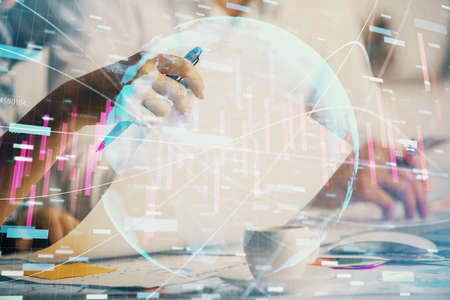 Double exposure of forex graph drawing over people taking notes background. Concept of financial analysisの写真素材