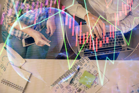 Multi exposure of man and woman working together and forex graph hologram drawing. Financial...