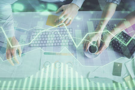 Double exposure of man and woman working together and financial chart hologram drawing. market...