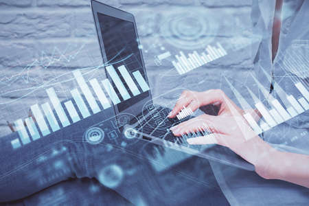 Multi exposure of woman hands typing on computer and forex chart hologram drawing. Stock market...