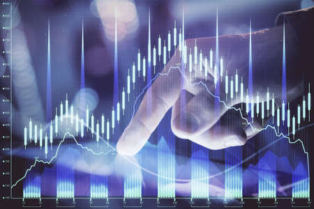 Multi exposure of mans hands holding and using a phone and financial chart drawing. Market analysis...