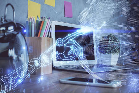 Computer on desktop in office with technology theme hologram. Double exposure. Tech concept.の写真素材