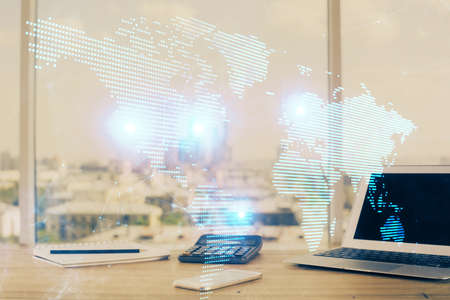Computer on desktop with social network hologram. Multi exposure. Concept of international people connections.の写真素材