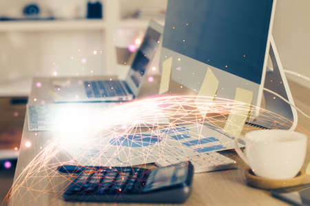 Computer on desktop with social network hologram. Multi exposure. Concept of international people connections.の写真素材